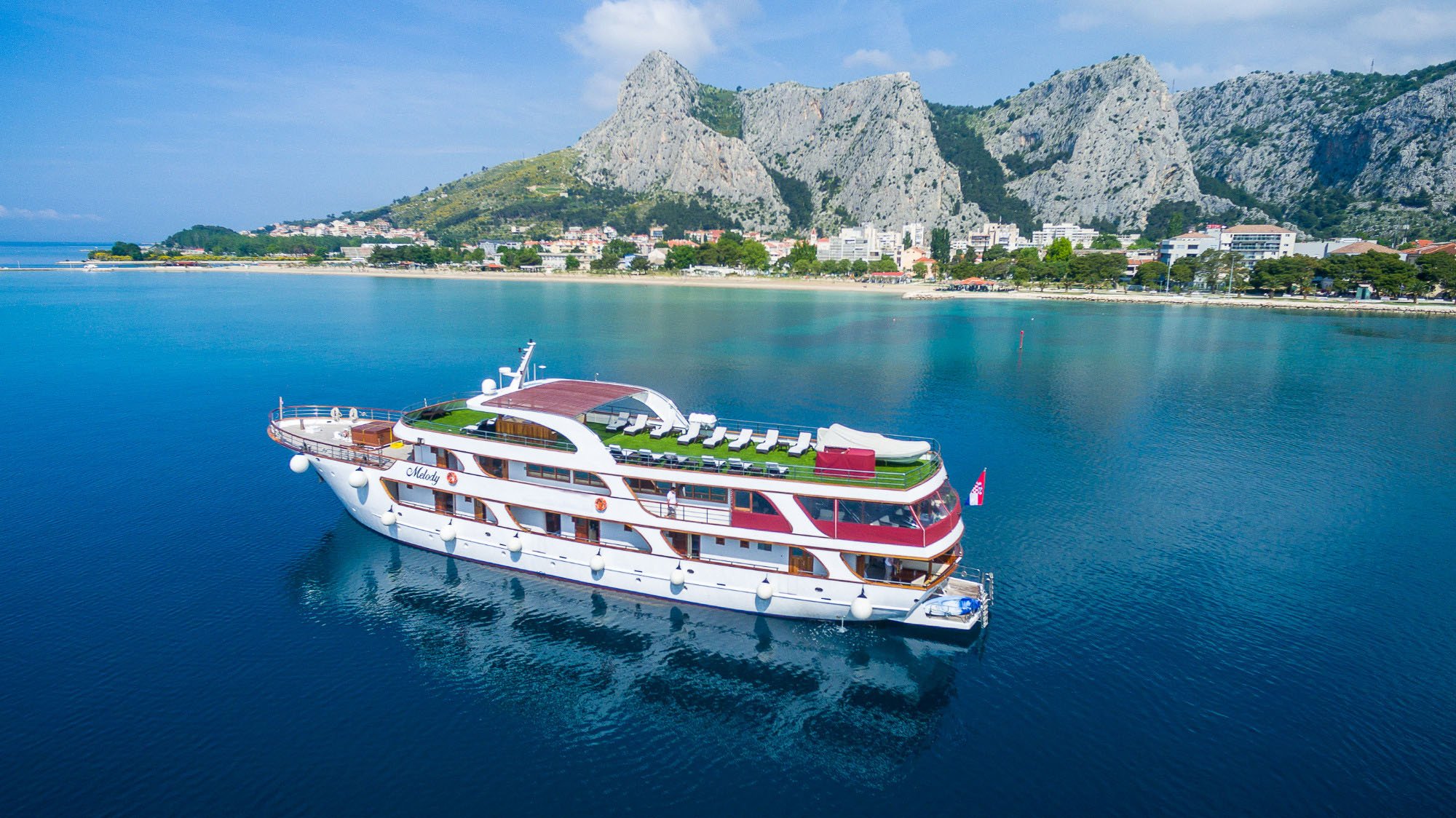 Melody boat Aerial View with mountains