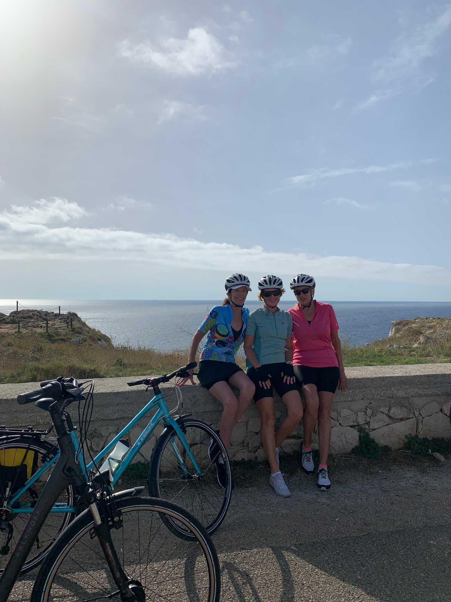 Italy's Puglia cyclists sitting by the ocean