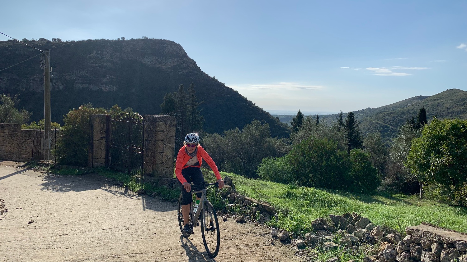 Sicily cycling tour cyclist with scenic mountain view